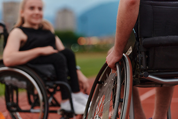 Image showing A woman with disability in a wheelchair talking with friend after training on the marathon course