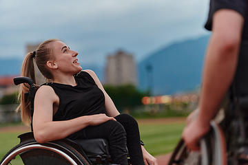 Image showing A woman with disability in a wheelchair talking with friend after training on the marathon course