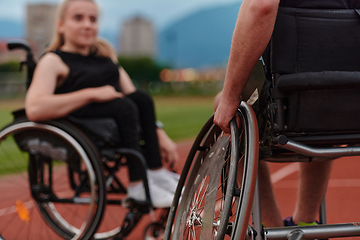 Image showing A woman with disability in a wheelchair talking with friend after training on the marathon course