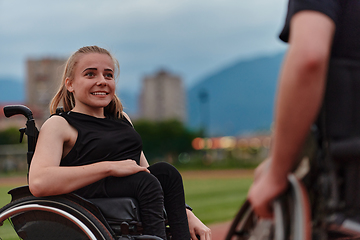 Image showing A woman with disability in a wheelchair talking with friend after training on the marathon course