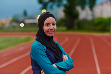 Image showing A Muslim woman with a burqa, an Islamic sportswoman resting after a vigorous training session on the marathon course. A hijab woman is preparing for a marathon competition