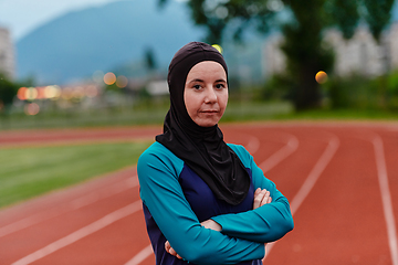 Image showing A Muslim woman with a burqa, an Islamic sportswoman resting after a vigorous training session on the marathon course. A hijab woman is preparing for a marathon competition