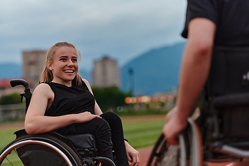 Image showing A woman with disability in a wheelchair talking with friend after training on the marathon course