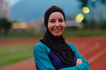 Image showing A Muslim woman with a burqa, an Islamic sportswoman resting after a vigorous training session on the marathon course. A hijab woman is preparing for a marathon competition
