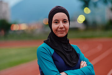 Image showing A Muslim woman with a burqa, an Islamic sportswoman resting after a vigorous training session on the marathon course. A hijab woman is preparing for a marathon competition