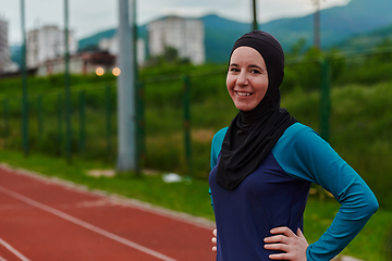 Image showing A Muslim woman with a burqa, an Islamic sportswoman resting after a vigorous training session on the marathon course. A hijab woman is preparing for a marathon competition