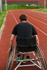 Image showing A person with disability in a wheelchair training tirelessly on the track in preparation for the Paralympic Games