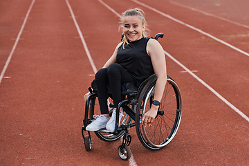 Image showing A woman with disablity driving a wheelchair on a track while preparing for the Paralympic Games