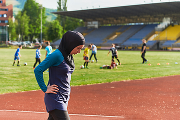 Image showing A Muslim woman with a burqa, an Islamic sportswoman resting after a vigorous training session on the marathon course. A hijab woman is preparing for a marathon competition