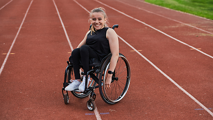 Image showing A woman with disablity driving a wheelchair on a track while preparing for the Paralympic Games