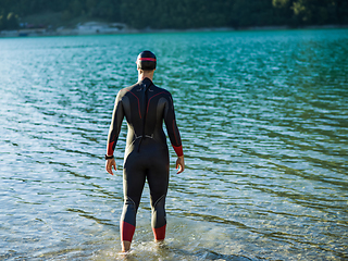 Image showing A triathlon swimmer preparing for a river training to gear up for a marathon