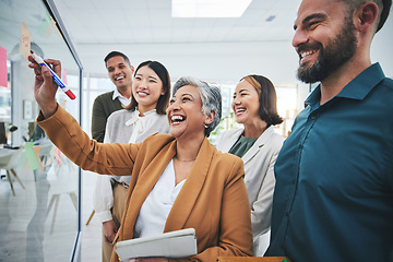 Image showing Senior woman, writing and laughing at glass board for creative sticky notes with group agenda. Calendar planning, content creator schedule and management staff in a business meeting with teamwork