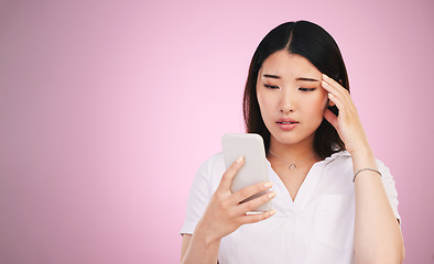 Image showing Space, phone and stress with face of woman in studio for networking, communication and worry. Social media, news and frustrated with asian person on pink background for technology, scam and mockup