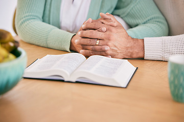 Image showing Reading, bible and senior couple holding hands at home with book study and religion together. Prayer, support and elderly people with worship, learning and christian education with love and care