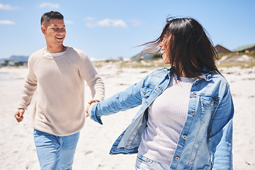 Image showing Love, smile and holding hands with couple at beach for travel, summer vacation and romance together. Happy, relax and bonding with man and woman walking on seaside holiday for care, date or honeymoon