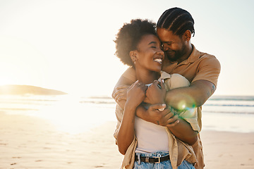 Image showing Beach sunset, love and happy black couple hug, sunshine and enjoy bonding time together on romantic Nigeria date. Marriage honeymoon, lens flare or hugging African people connect on anniversary break