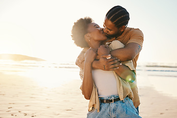 Image showing Beach sunset, sunshine and black couple hug, kiss and enjoy time together, support and romance on travel holiday. Marriage, flare or hugging African people connect, care and bond on anniversary break