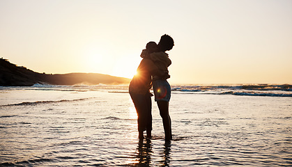 Image showing Beach, sunset and silhouette of couple hug, connect and enjoy romantic time together, bonding and relax in sea water. Dark shadow, summer love or outdoor people embrace on tropical marriage honeymoon