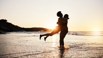 Image showing Beach sunset, silhouette and couple hug, celebrate and enjoy romantic time together, bonding and relax in sea water. Wellness, summer freedom and dark shadow of people embrace on tropical anniversary