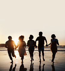 Image showing Silhouette, summer and friends holding hands at sunset beach for fun and travel. Banner space, men and women group running outdoor in water with love, support and happiness on vacation or holiday