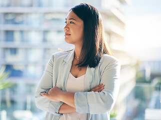 Image showing Thinking, crossed arms and businesswoman in the office with confidence and brainstorming ideas. Young, career and professional Asian female lawyer standing and planning with pride in modern workplace