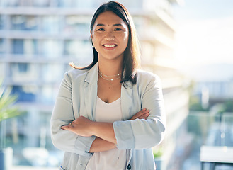 Image showing Smile, crossed arms and portrait of a businesswoman in the office with confidence and happiness. Pride, career and face of a happy professional young Asian female lawyer standing in modern workplace.