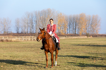 Image showing Hungarian csikos horsewoman in traditional folk costume