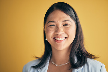 Image showing Face, smile and Asian woman, designer and entrepreneur in studio isolated on a yellow background mockup space. Portrait, happy and creative professional, worker and startup employee in Cambodia.