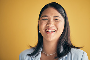 Image showing Face, happy and Asian woman, designer and entrepreneur in studio isolated on a yellow background mockup space. Portrait, funny and creative professional, worker laugh and startup employee in Cambodia
