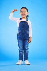 Image showing Young, girl child and champion, winner and emoji with happiness, strong and excited isolated on blue background. Power, muscle and winning with success, body language and happy kid in a studio