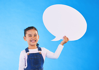 Image showing Girl child, speech bubble and studio portrait for smile, mockup space and excited by blue background. Female kid, paper billboard and happy for news, info and promo of deal, discount and social media