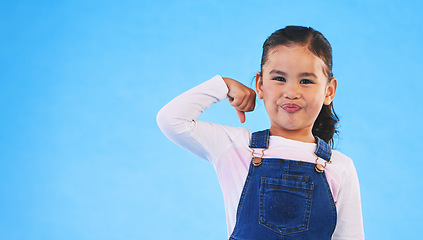 Image showing Portrait, girl child and champion, winner and emoji with happiness, strong and excited isolated on blue background. Power, mockup space and winning with success, body language and happy kid in studio