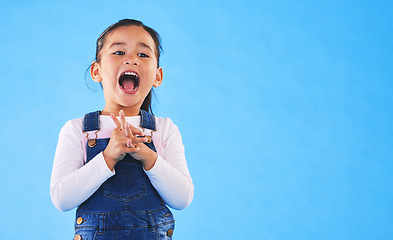 Image showing Excited, youth and a child on a blue background with mockup for information. Playful, freedom and a young girl kid or model playing with happiness on a studio background with space for creativity