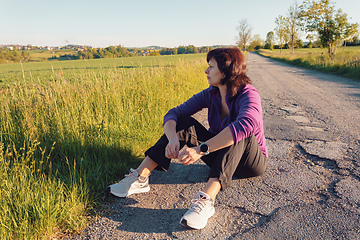 Image showing happy european woman resting on road