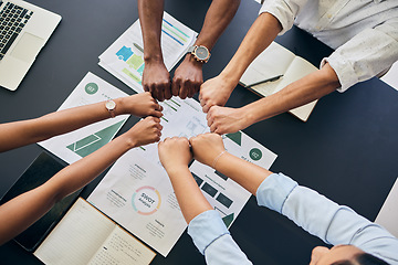 Image showing Fist circle, business people and documents with group, teamwork and planning at startup, office or top view. Team building, hands and synergy with link, connection or paperwork for start in workplace