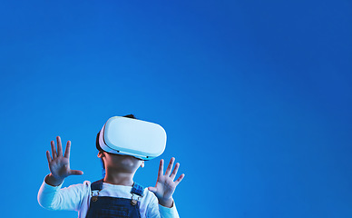 Image showing Futuristic, girl or kid virtual reality glasses, online gaming or technology on blue studio background. Child, future or vr headset for video game, esports experience or mockup space with innovation