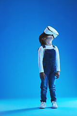 Image showing Glasses, virtual reality and metaverse with girl, future and digital transformation on a blue studio background. Kid, mockup space and model with vr headset for video games, futuristic and innovation