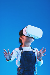 Image showing Metaverse, girl and child virtual reality glasses, innovation and future on a blue studio background. Kid, vr headset or technology for online gaming, futuristic and augmented reality with connection