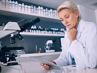 Image showing Science, tablet and thinking with woman in laboratory for research, medical and pharmacy. Medicine, healthcare and digital report with mature scientist reading online for email, data and results