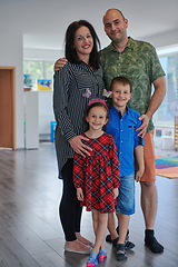 Image showing Portrait of a happy family. Photo of parents with children in a modern preschool classroom. Selective focus