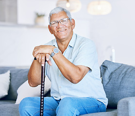 Image showing Portrait, home and old man with a walking stick, relax and support with retirement, peace or calm on a couch. Senior person in a living room, elder or pensioner on a sofa, cane or health with a smile