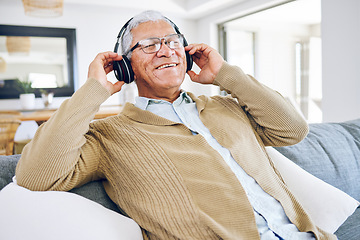 Image showing Senior man, headphones and listening to music in home, living room and relax on lounge sofa with podcast, radio or sound. Streaming, jazz song and audio with earphones and mobile technology in house