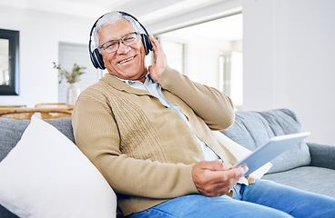 Image showing Portrait, home and old man with tablet, headphones and smile with connection, streaming music and radio. Senior person, technology and pensioner with headset, listening to audio and sound on a couch