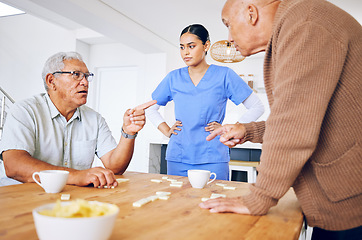 Image showing Nurse, senior and fighting over a game of dominoes with people in a retirement home for assisted living. Healthcare, medical and a female medicine professional looking at upset old men arguing