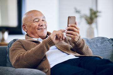 Image showing Smile, typing and a senior man with a phone on the sofa for social media, contact or commmunication. Happy, relax and an elderly person on the home couch with a mobile for an app or reading a chat