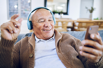 Image showing Phone, senior man and watch music video, streaming podcast and reading happy story, news article or retirement blog. Home, smartphone and elderly person with headphones, relax and listening to song