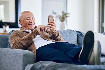 Image showing Smile, relax and a senior man with a phone on the sofa for social media, contact or commmunication. Happy, online and an elderly person on the home couch with a mobile for an app or typing a chat