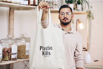 Image showing Man at eco friendly grocery store, fabric shopping bag and commitment to climate change at sustainable small business. Zero waste, plastic kills logo and supermarket with carbon footprint choice.