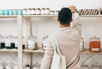 Image showing Man, back and shopping by shelf in grocery store for healthy food, nutrition and wellness product sales. Choice, decision and customer nutritionist in supermarket for retail purchase, buying or deal