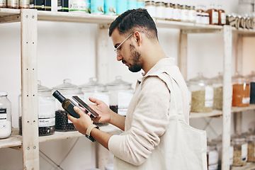 Image showing Man, shopping and phone for reading grocery product, healthy food and organic oil information in store. Research, thinking and nutritionist customer with technology for supermarket choice or decision